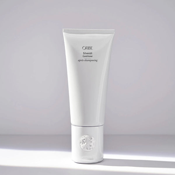 Oribe Silverati Conditioner – tall white luxury tube with embossed crest cap, brightening and softening formula for silver, gray, and white hair.