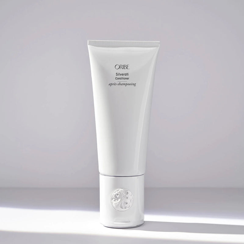 Oribe Silverati Conditioner – tall white luxury tube with embossed crest cap, brightening and softening formula for silver, gray, and white hair.