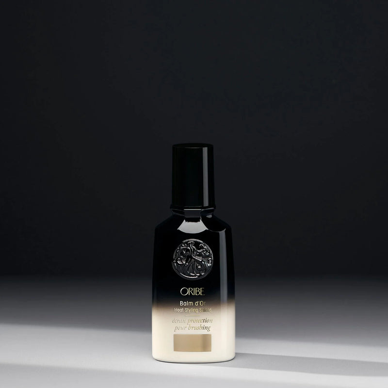 Oribe Balm d’Or Heat Styling Shield – super‑lightweight thermal balm with cassis, sandalwood and maracuja oils plus heat-activated polymer technology to protect hair up to 450 °F, smooth frizz and seal in shine.