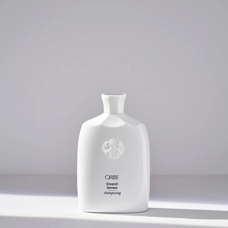 Oribe Silverati Shampoo – luxury white sculpted bottle with embossed crest, designed to brighten and soften silver, gray, and white hair.