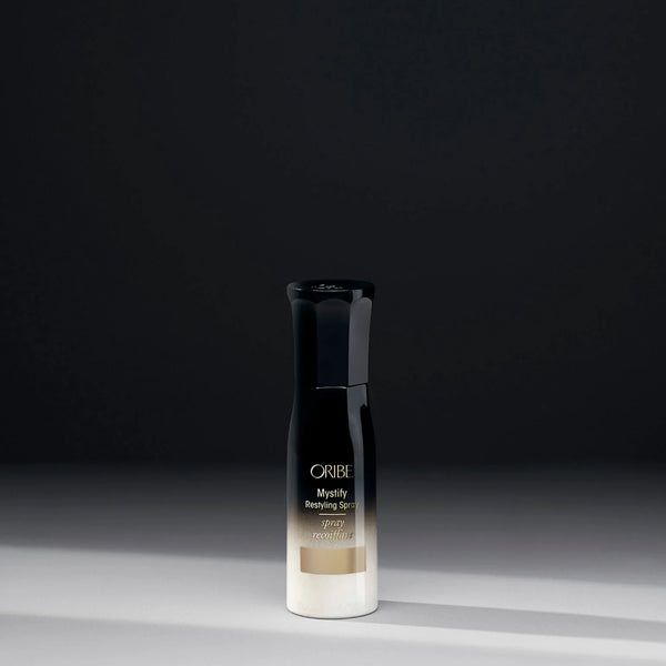 Oribe Mystify Restyling Spray travel size – lightweight hydrating mist to refresh second‑day styles, with avocado oil, lactic acid, bio‑restorative complex for heat protection and lightweight hold.