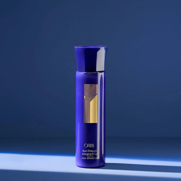 Oribe Run-Through Detangling Primer – lightweight conditioning detangler with pomegranate, apricot & coconut oils plus tropical hibiscus & amino acids to hydrate, detangle and seal cuticles for shiny, tangle‑free hair.