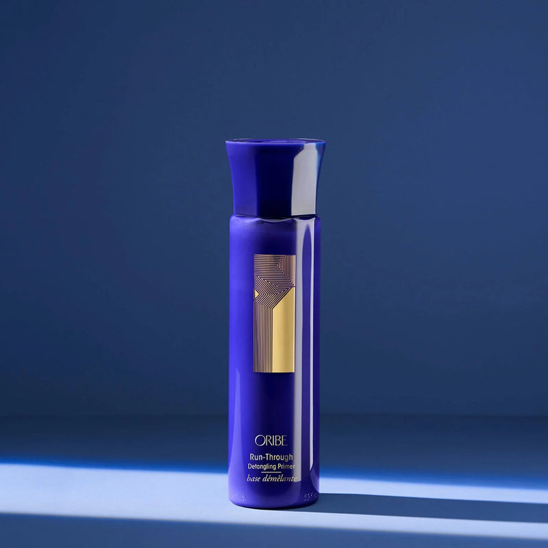 Oribe Run-Through Detangling Primer – lightweight conditioning detangler with pomegranate, apricot & coconut oils plus tropical hibiscus & amino acids to hydrate, detangle and seal cuticles for shiny, tangle‑free hair.