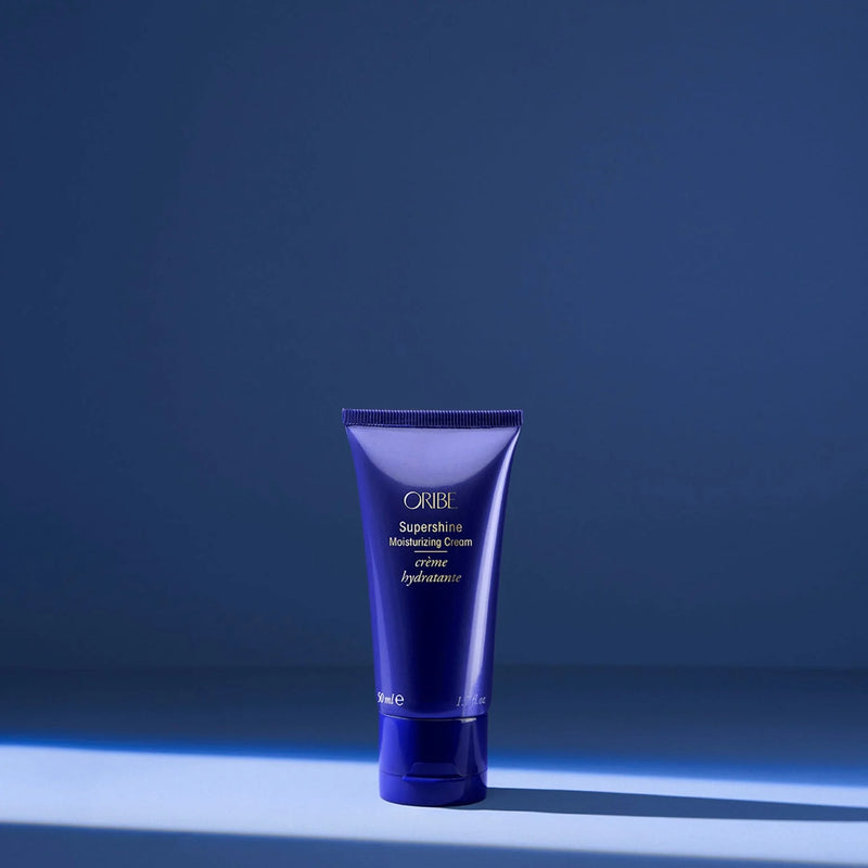 Oribe Supershine Moisturizing Cream travel-size tube — a rich leave-in styling cream that smooths frizz, adds high-gloss shine, and hydrates dry or coarse hair on the go.