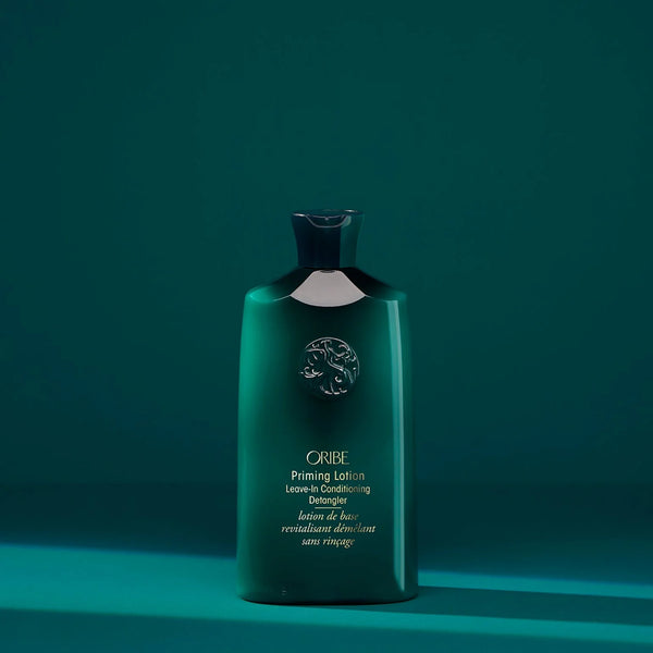 Oribe Priming Lotion Leave-In Conditioning Detangler in a luxe blush-toned tube — a silky, ultra-hydrating leave-in formula that detangles, conditions, and preps curly or coily hair for styling.