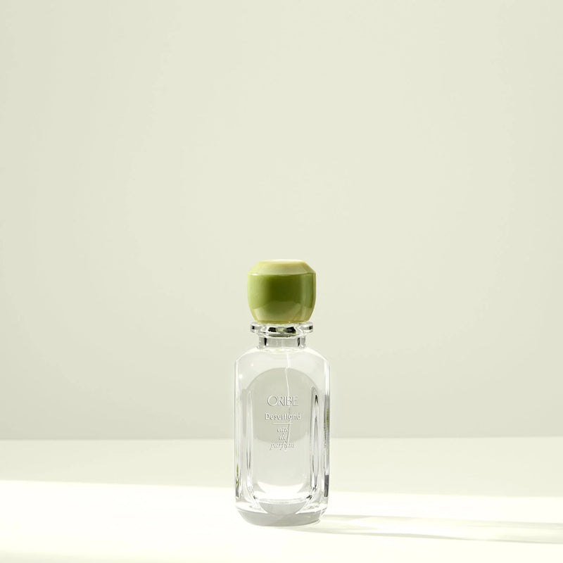Oribe Desertland Eau de Parfum bottle with green cap – unisex luxury fragrance with juniper berry, wildflowers, and cedarwood notes.