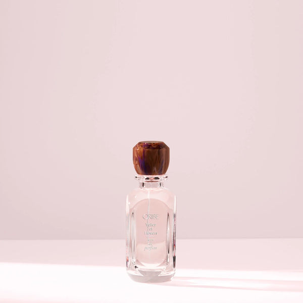 Oribe Valley of Flowers Eau de Parfum bottle with faceted cap, luxury floral fragrance featuring rose, peony, and amber notes.
