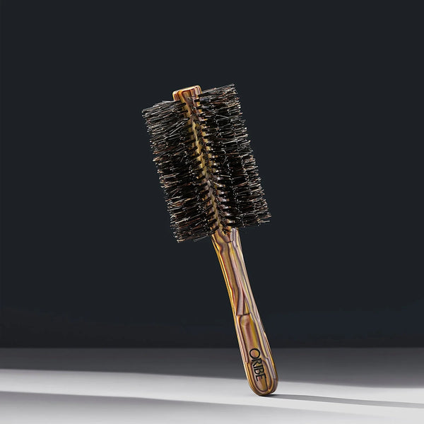 Oribe Italian Resin Large Round Brush – professional tortoiseshell-patterned handle with large round barrel and natural boar bristles for blow-drying and voluminous styling.