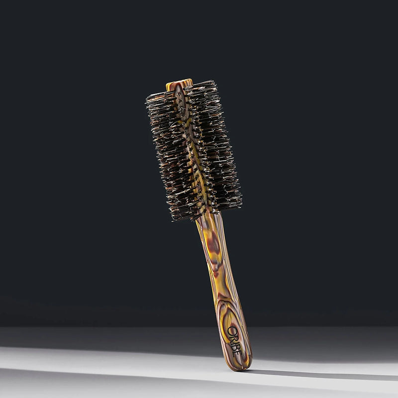 Oribe Italian Resin Medium Round Brush – tortoiseshell-patterned handle with dense natural bristles, medium barrel for smooth blowouts and volume styling.