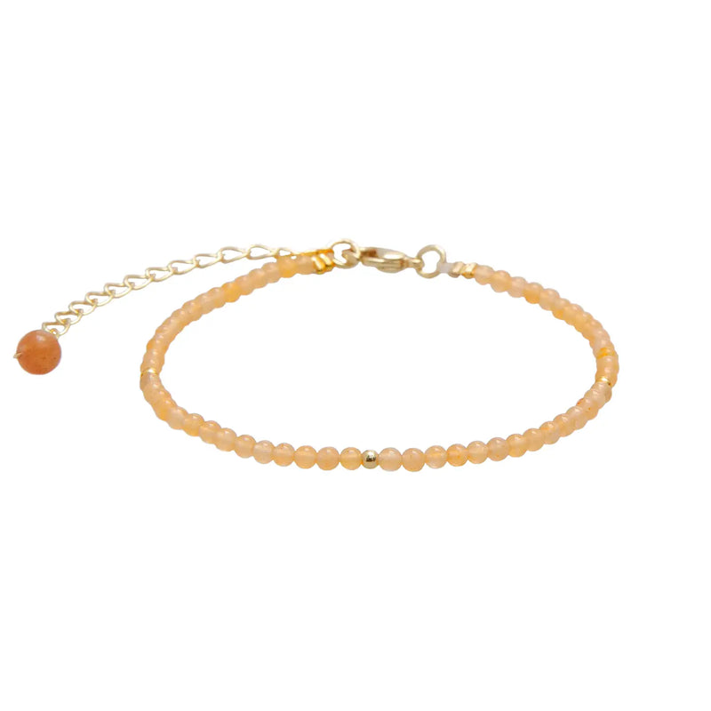 Lotus & Luna 2 mm Healing Bracelet – peach/orange gemstone beads with gold accent and adjustable chain clasp.