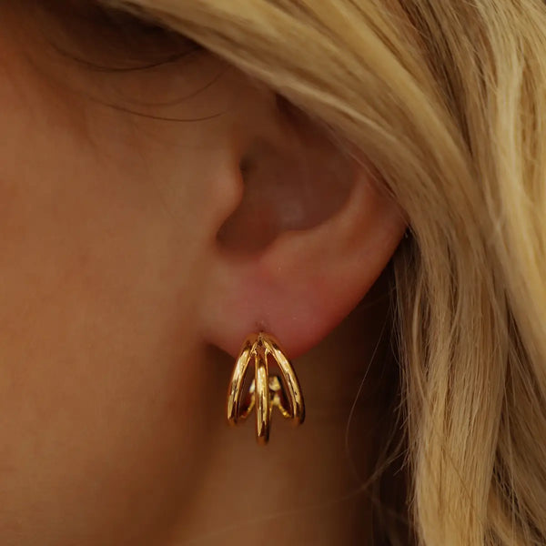 Gold triple hoop stud earrings by Katie Waltman displayed on a jewelry card – minimal, elegant, and perfect for layering.