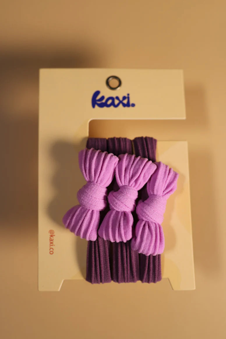 KAXI Two‑Toned Bow Slick Back Ponytails Pack (3‑count) in Plum + Lavender – stretchy spandex hair ties without inner elastic to prevent damage, featuring dual‑tone plum and lavender bow design for no‑slip all‑day hold and polished styling at workouts or everyday wear.