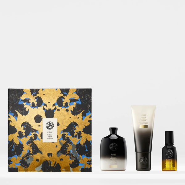Oribe Gold Lust Collection Holiday Gift Set with shampoo, conditioner, and hair oil — luxury haircare gift box featuring full-size restorative products for damaged hair.