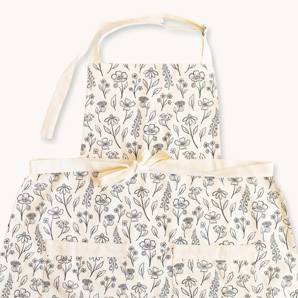 Elyse Breanne Design apron pressed floral print – adjustable cotton kitchen apron with front pockets and botanical black and white design.