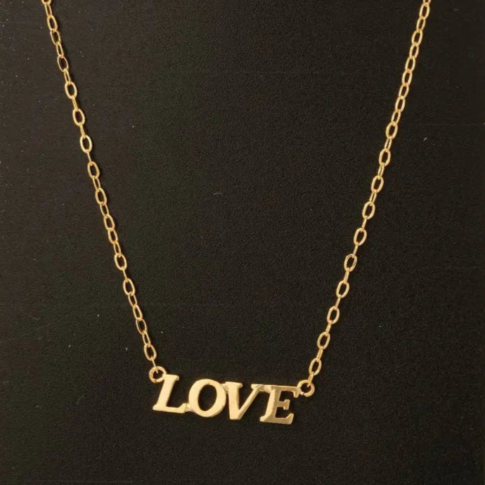 This necklace is a trendy option featuring the word "love" in a pendant with a sleek, minimal design. Perfect for adding a touch of love and sophistication to any outfit, this necklace is ideal for gifting on special occasions like anniversaries, Valentine's Day, or birthdays.