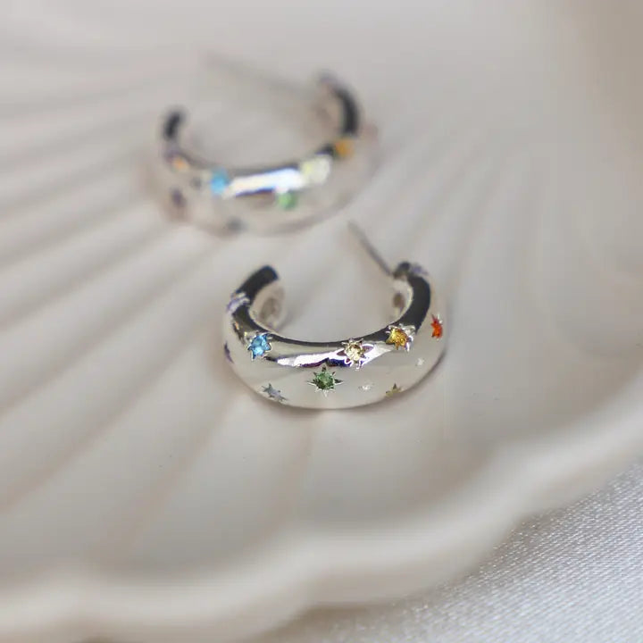 Katie Waltman Penny CZ Star Hoop Earrings in silver, featuring delicate huggie hoops with dangling star charms encrusted with cubic zirconia for a celestial sparkle — perfect for adding shimmer to casual or evening looks.