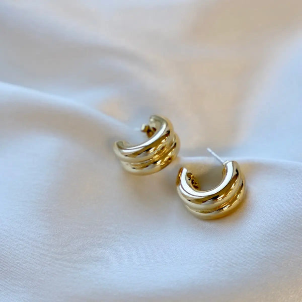 Gold chunky double hoop earrings by Katie Waltman, modern sculptural statement jewelry for women.