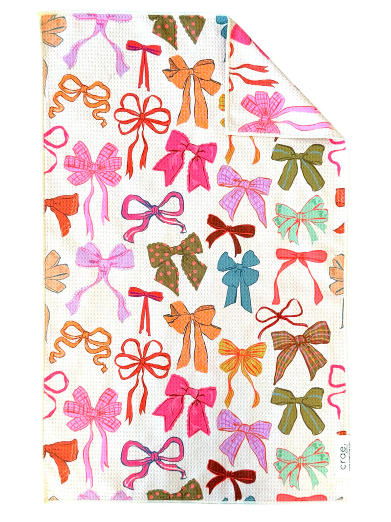Crae Home Perfectly Tied reversible hand towel – a lovely variety of bows on a waffle‑weave microfiber towel in cream, double‑sided for kitchen or bath.
