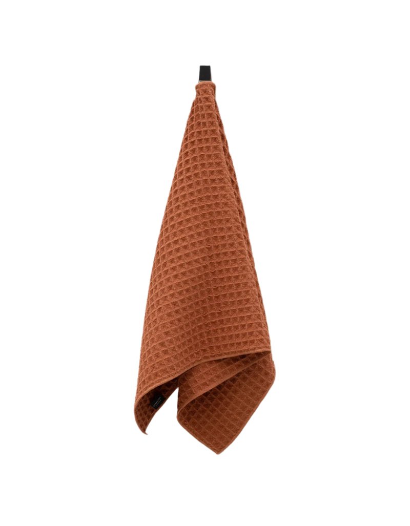 Geometry House Clay Waffle Hand Towel with textured weave and earthy terracotta tone. It is quick-dry, sustainable, and modern. 