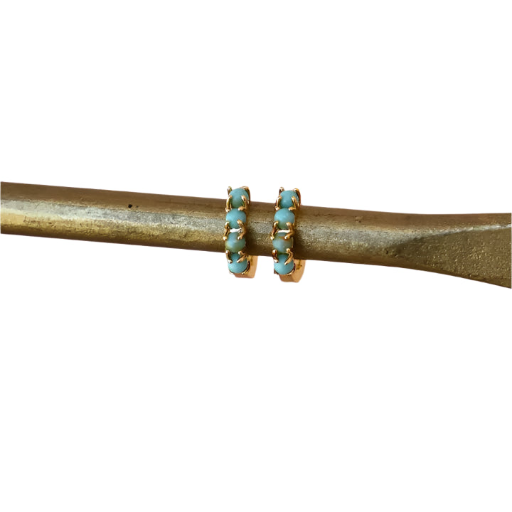 Katie Waltman Mini Turquoise Hoop Earrings featuring small gold-toned huggie-style hoops adorned with vibrant turquoise stones — perfect for adding a pop of color to everyday outfits or earring stacks.