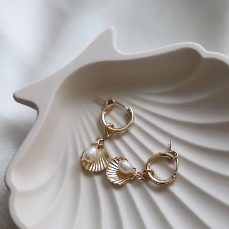 From Katie Waltman, Seychelles Hoop Earrings. These earrings are a Stunning hoop style earrings featuring a unique design with a coastal-inspired touch. Perfect for adding a bold, elegant statement to any outfit, these high-quality earrings are ideal for both casual and formal occasions. High quality, lasting materials, making them a great choice to purchase.