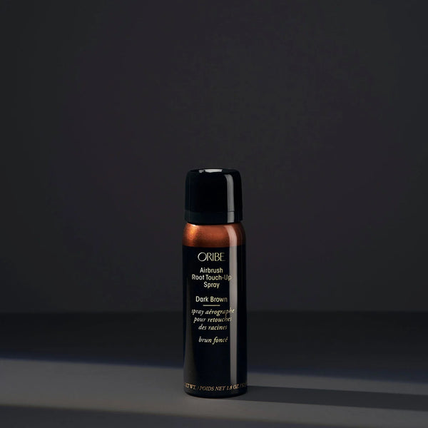 Oribe Airbrush Root Touch-Up Spray in Dark Brown – slim black aerosol can with dark brown cap and upper panel, gold logo, and microfine powder formula for seamless root coverage.