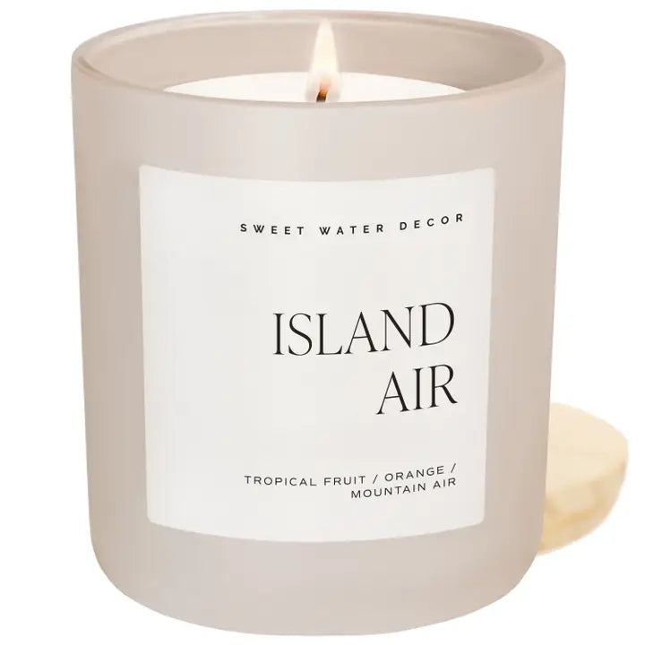 From Sweet Water Decor, escape to paradise with the 'Island Air' 15oz soy candle - tropical fruits, citrus zest, and exotic green scents. Bring the islands to your home with this candle. Makes a great gift or for yourself! Contains non-toxic ingredients, so you can feel safe burning it in your home. 