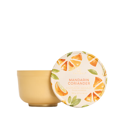 Mandarin Coriander scented candle in a orange, yellow tin with a decorative lid featuring vibrant orange slices and green leaves, ideal for home fragrance and gifting. Has a great citrus scent!